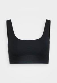 Black seamless sports bra with wide straps and a fitted elastic band featuring a subtle "GAP" logo on the front center.