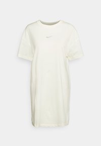 Krämfärgad oversized t-shirt klänning i mjuk bomull. Har en rundad halsringning och en liten, diskret logga på bröstet.