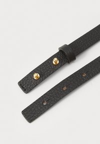 Black textured leather strap with two gold tone metal studs and a leather loop, featuring holes for adjustable fastening.