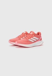 Athletic shoes with a breathable pink mesh upper, white stripes, and a cushioned sole. Features rubberized accents and lightweight design.