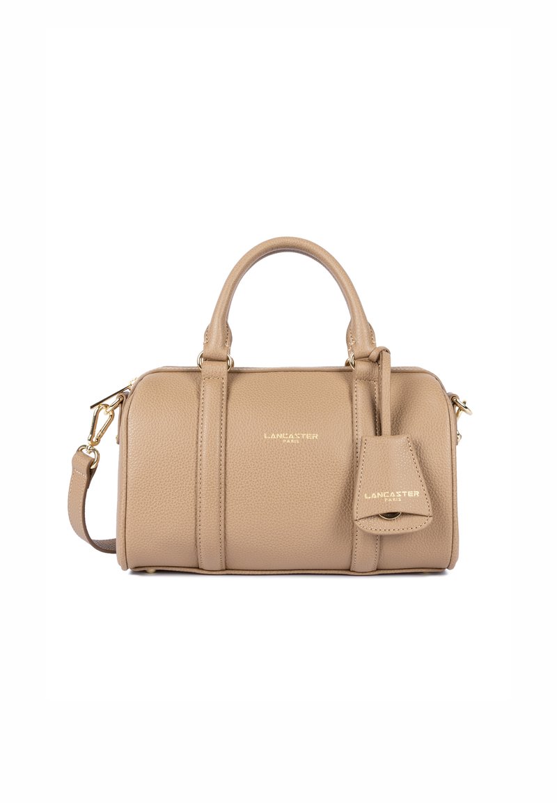 Tan leather handbag with a textured finish, dual handles, detachable shoulder strap, gold hardware, and a small attached tag.
