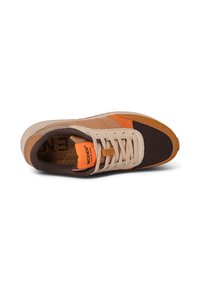 Tan and brown sneakers with orange accents. Features a textured upper, perforated sections, and a sturdy rubber sole. Woven logo on tongue.