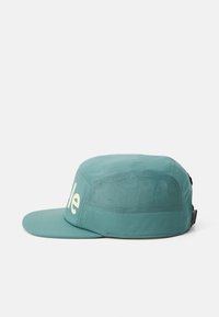 Teal cap with a flat brim and mesh panels. Features a light-colored brand name on the front. Smooth texture with stitched accents.