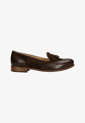 Brown leather and suede flat shoe with a rounded toe, brogue detailing, and a decorative tassel on the vamp. Low wooden heel.