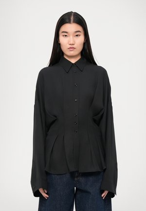 Black button-up shirt made of lightweight fabric, featuring a pointed collar, pleated design, and long sleeves with buttoned cuffs.