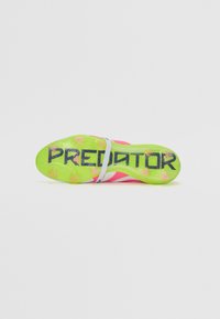 Football boot with a vibrant pink upper, green outsole, and black "PREDATOR" branding. Features a textured design and molded studs.
