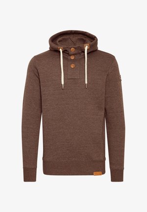 Rjava majica s kapuco, tremi lesenimi gumbi in kremnimi vrvicami. Ima rebraste manšete in usnjen logotip na robu.