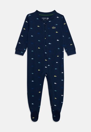 Body bébé bleu marine à manches longues, recouvert de petits logos crocodile multicolores, avec fermeture éclair à l'avant et pieds intégrés.