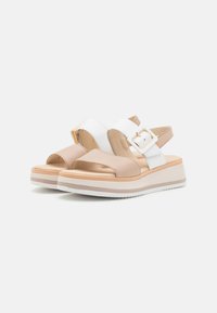 Layered sandals with a beige and white color scheme. Features adjustable straps, a buckle accent, and a cushioned platform sole.