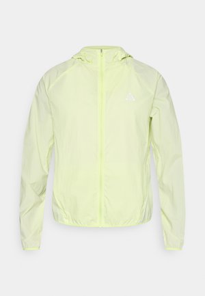 Kerge zip-up jakk fluoriseerivas kollases, millel on kapuuts, elastsed mansetid ja väike logo rinnal. Sile, kergelt kortsus tekstuur.