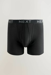 Bóxers de algodón negro con una cintura elástica gris de marca. Presentan una textura suave y un diseño ajustado con detalles de costura central.