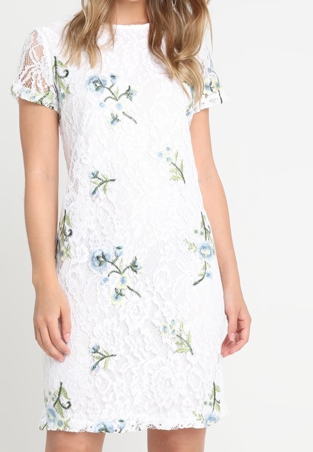 White lace dress with short sleeves, featuring embroidered blue floral patterns. Straight shape with a scalloped hem and textured fabric.