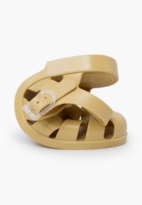 Yellow rubber sandal with a woven design, featuring a flat sole and adjustable strap. Flexible material allows for easy folding and storage.