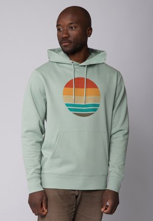 Mint green hoodie with a central graphic of a sunset in orange and blue hues, featuring a front pocket and adjustable drawstrings.