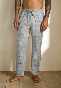 Šedé kárované nohavice na voľný čas z mäkkej tkaniny, s elastickým pásom na šnúrku a voľným strihom.