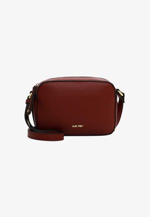 Red textured leather crossbody bag with adjustable strap, zip closure, and gold embossed logo. Rectangular shape with black trim accents.