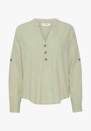 Hellegrüne Langarmbluse aus weichem Stoff mit durchgeknöpftem Verschluss und abgerundetem Saum. Verfügt über zwei Knöpfe an jedem Ärmel als Detail.