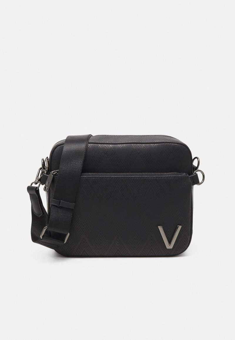 Schwarze Crossbody-Tasche mit strukturierter Oberfläche, vorderer Reißverschlusstasche, verstellbarem Riemen und metallischem "V"-Logo in der unteren rechten Ecke.