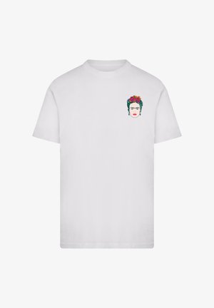 White short-sleeve T-shirt with a small colorful graphic of a woman's face adorned with flowers on the upper left chest.