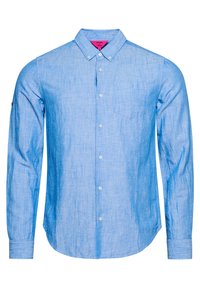 Camicia a maniche lunghe di colore azzurro chiaro, con tessuto strutturato, una piccola tasca sul petto e colletto classico. Caratterizzata da bottoni bianchi e dettagli cuciti.
