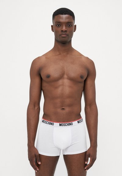 White boxer briefs with a black and red "MOSCHINO" waistband; smooth, stretchy fabric; fitted cut; no patterns or additional details.
