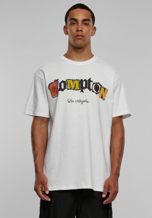 Hvit bomull t-skjorte med avslappet passform, med en fargerik "Compton, Los Angeles" grafikk med varierende skrifttyper og stiler på forsiden.