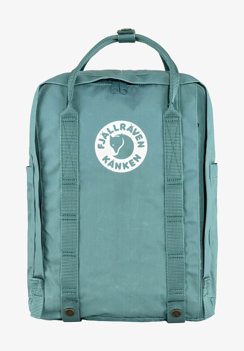 Teal Fjällräven Kånken backpack made of durable fabric, featuring two side pockets, a top handle, and a circular logo on the front.