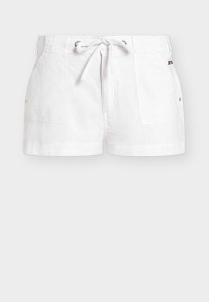 White cotton shorts with front patch pockets, silver eyelets, and a white drawstring tie at the waistband.