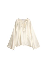 Kremfarget bluse med avslappet passform, vide ermer og detaljer med knytning i halsen. Laget av lett, glatt stoff med en subtil glans.