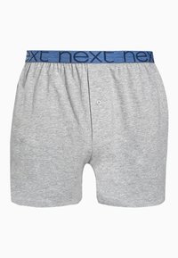 Boxeri gri din bumbac cu o talie elastică moale de culoare albastră, purtând logo-ul "next", și un închizător cu un singur buton în față.