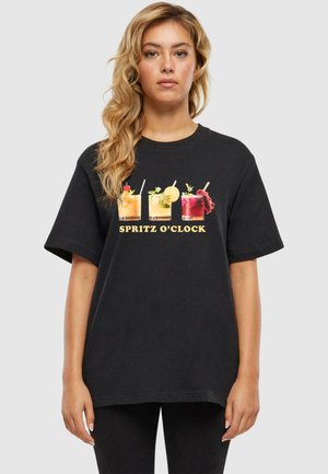 Black cotton t-shirt featuring colorful cocktail graphics with "SPRITZ O’CLOCK" text. Short sleeves and relaxed fit.