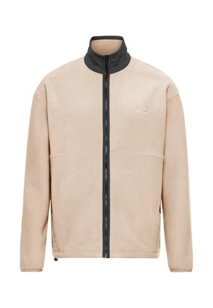 Veste en polaire beige avec col haut noir et fermeture éclair centrale, dotée de poches latérales et d'un petit logo brodé sur la poitrine.