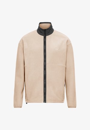 Veste en polaire beige avec col haut noir et fermeture éclair centrale, dotée de poches latérales et d'un petit logo brodé sur la poitrine.
