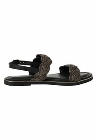 Sort sandal med flettede metalaccenter over vristen, justerbar ankelrem og flad glat sål. Diskrete guldtrim detaljer.