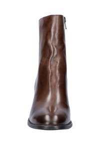 Bottes chelsea en cuir marron avec bout arrondi et fermeture éclair sur le côté, texture lisse et semelle en caoutchouc noire, présentées de face.