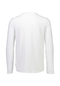 Pitkähihaiseen paita, jossa on tasainen valkoinen väri. Valmistettu sileästä kankaasta, jossa on pyöreä pääntie. Siinä on suora takasauma ja kiinnitetyt hihat. Ei näkyviä logoja.