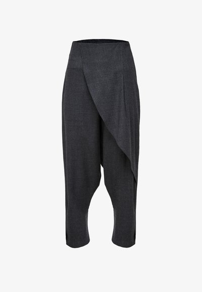 Tumed hallid, kerge kangas püksid, millel on asümmeetriline rippuv disain, lühendatud pikkus ja küljed lõhikute jaoks mugavuse ja liikumise tagamiseks.