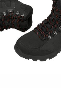 Scarpe da trekking nere realizzate in materiale sintetico, con una finitura texturizzata, lacci rossi e neri, occhielli in metallo e suola robusta per una migliore aderenza.