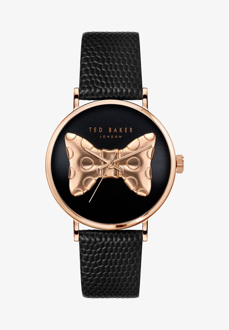 Orologio tondo nero con cinturino in pelle nera texturizzata. Design a farfallino dorato sul quadrante con pois e marchio "TED BAKER LONDON".