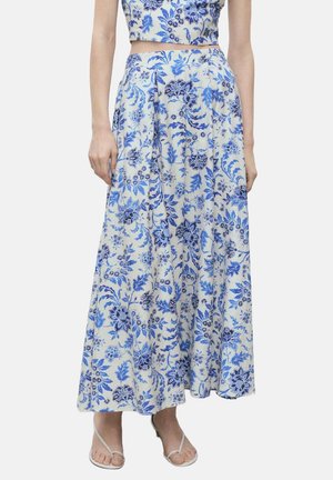 Blue and white floral printed maxi skirt, cotton material, flared shape, high waist, featuring detailed botanical patterns and side seams.