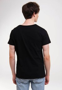 Black short-sleeve t-shirt with a round neck; made of soft cotton; smooth texture; fitted silhouette; back view with no visible logos or patterns.