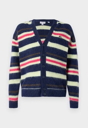Cardigan à rayures navy fabriqué dans un tissu doux, avec des rayures horizontales jaunes, roses et brunes. Fermeture à cinq boutons et décolleté en V.