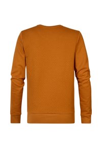 Sweat-shirt à manches longues de couleur orange brûlé avec un motif matelassé en losanges dans le dos, poignets et ourlet côtelés, vu de dos.