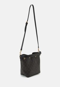 Brown checkered handbag with a structured design, leather material, a single adjustable strap, and gold-tone hardware accents.