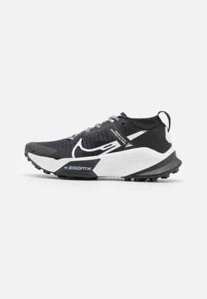 Chaussure de course Nike ZoomX noire et blanche avec tige en maille, lacets à motifs et semelle robuste, vue de côté extérieure sur fond blanc.