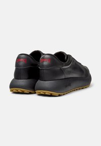Black leather sneakers with a smooth texture, featuring a thick rubber sole and red "CAMER" branding on the heel. Round toe design.