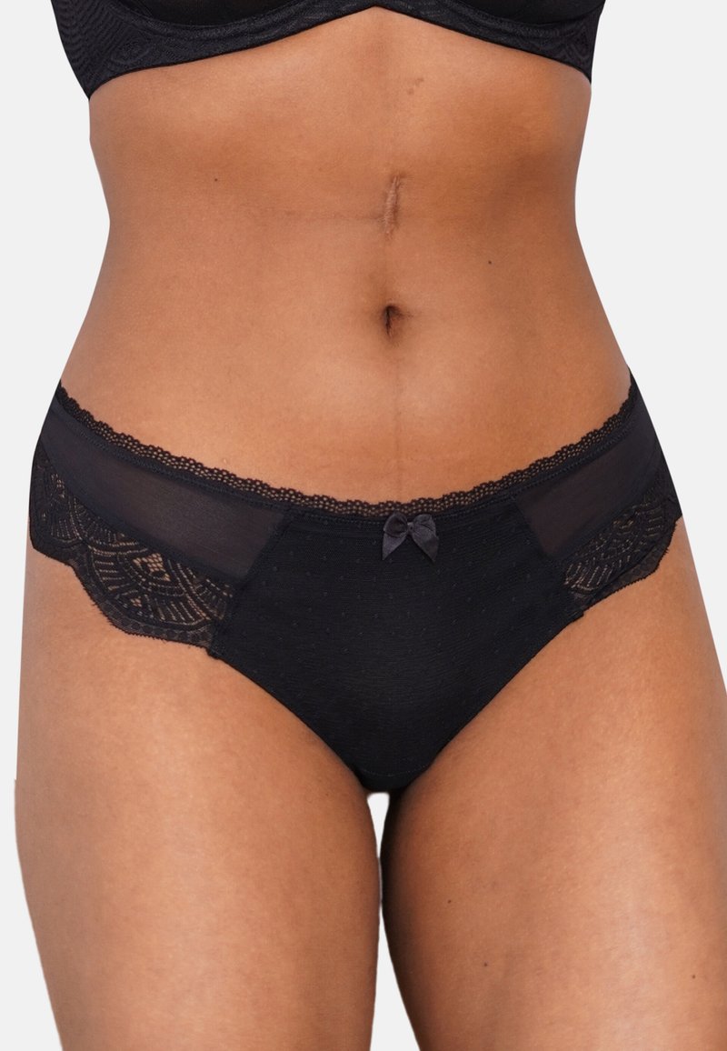 Schwarze Damenunterwäsche mit einer Spitzenborte, durchsichtigen Mesh-Einsätzen und einem kleinen Schleifenakzent vorne. Glatte Textur mit Punktmuster.