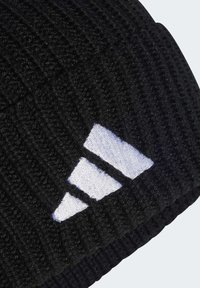 Black knitted beanie with ribbed texture, featuring a white embroidered logo consisting of three diagonal stripes.