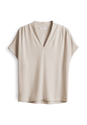 Beige short-sleeve top with a V-neck and pleated details at the shoulders; textured fabric with smooth finish and a relaxed fit.