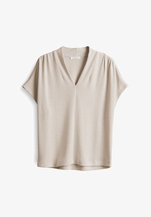 Beige short-sleeve top with a V-neck and pleated details at the shoulders; textured fabric with smooth finish and a relaxed fit.